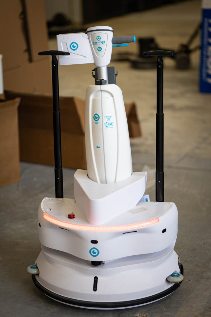 A high-tech i-mop XL autonomous robotic floor scrubber sits ready for service in the WaySolutions repair facility in Layton, Utah.
